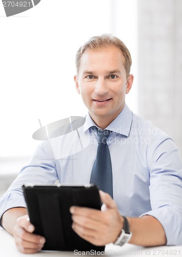 Image of businessman with tablet pc in office