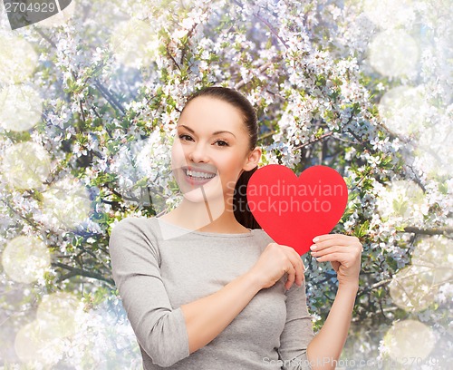 Image of smiling asian woman with red heart