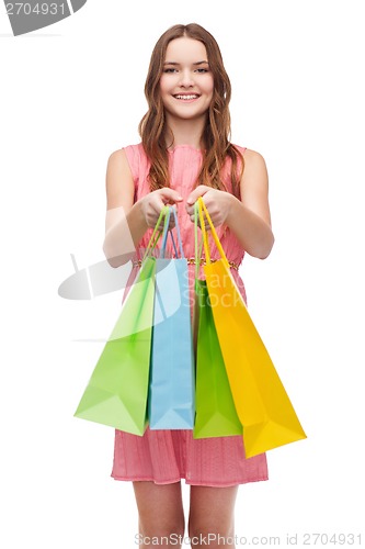 Image of smiling woman in dress with many shopping bags