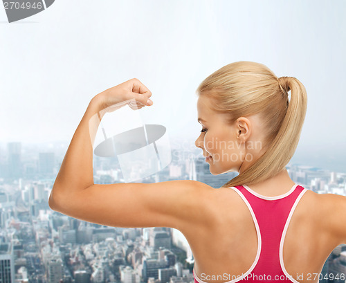 Image of sporty woman showing her biceps