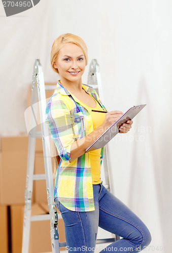 Image of smiling woman with clipboard