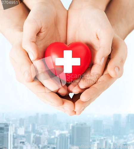 Image of male and female hands with red heart