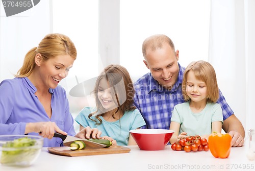 Image of happy family with two kids making dinner at home