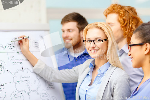 Image of smiling businesswoman with team team on the back