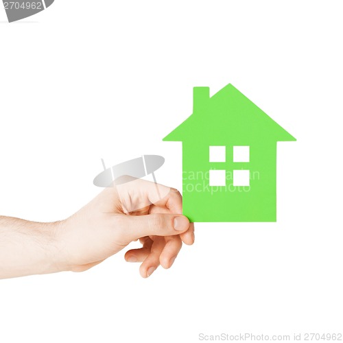 Image of hand holding green paper house