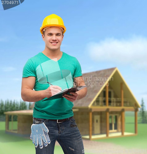 Image of smiling man in helmet with clipboard