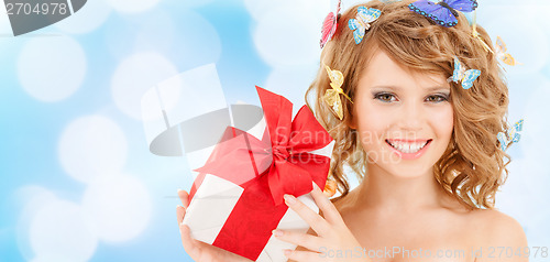 Image of teenager with butterflies in hair showing present