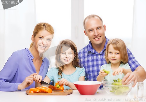 Image of happy family with two kids making dinner at home