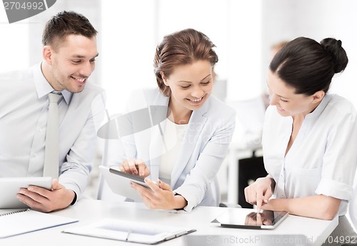 Image of business team working with tablet pcs in office