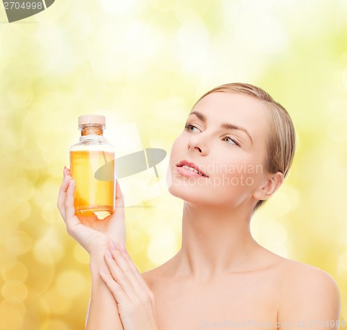 Image of lovely woman with oil bottle