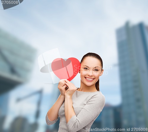 Image of smiling asian woman with red heart