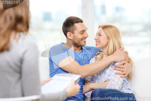 Image of young couple hugging at psychologist office