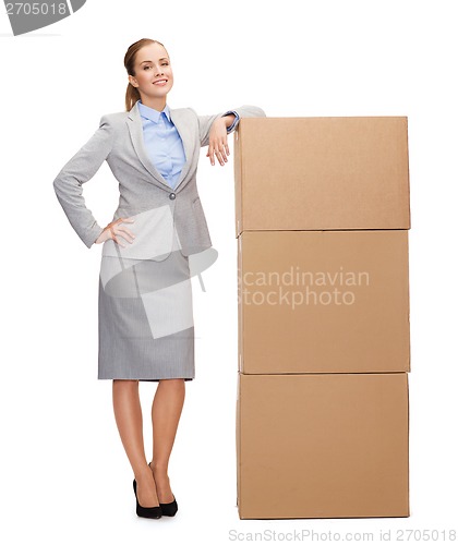 Image of smiling businesswoman with cardboard boxes