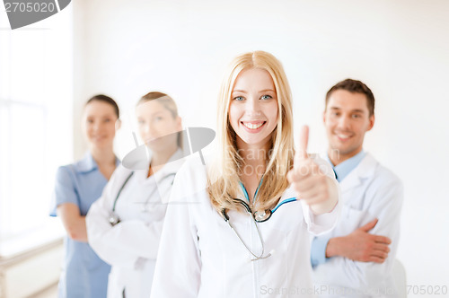 Image of female doctor or nurse in front of medical group