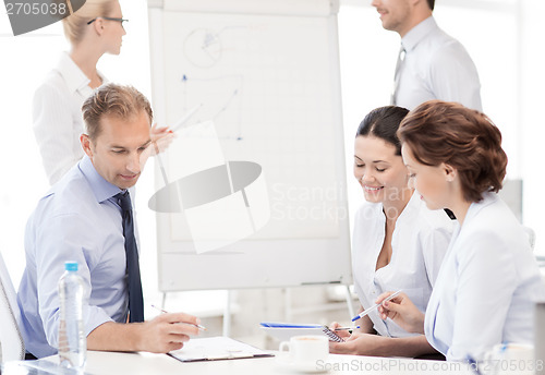 Image of business team discussing something in office