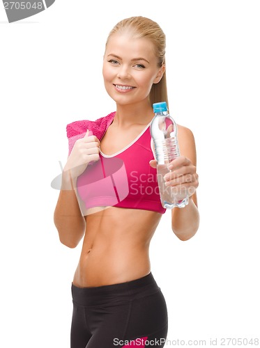 Image of sporty woman with bottle of water and towel