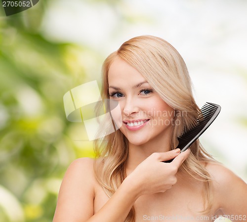 Image of smiling woman with hair brush