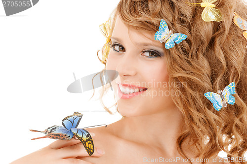 Image of happy teenage girl with butterflies in hair