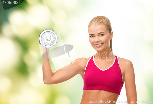 Image of smiling woman with heavy steel dumbbell