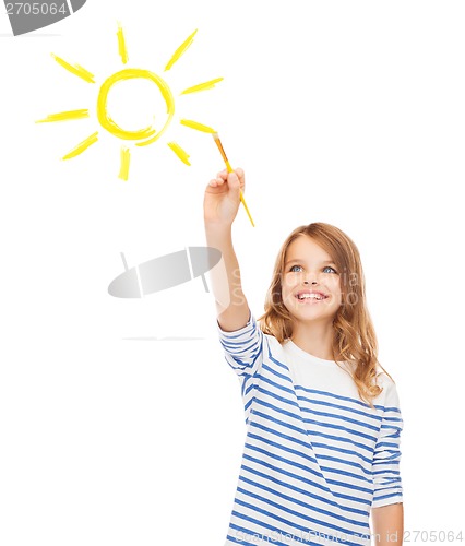 Image of cute little girl drawing sun with brush