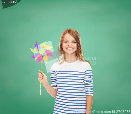 Image of smiling child with colorful windmill toy