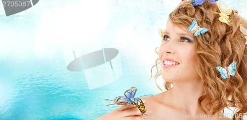 Image of happy teenage girl with butterflies in hair