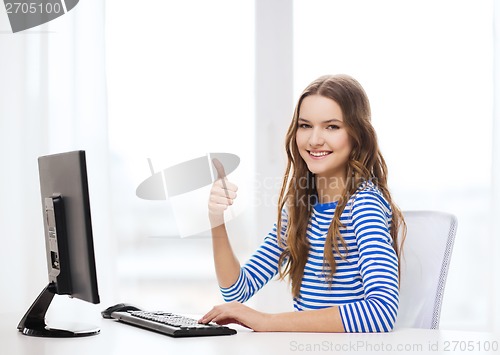 Image of dreaming teenage girl with computer at home