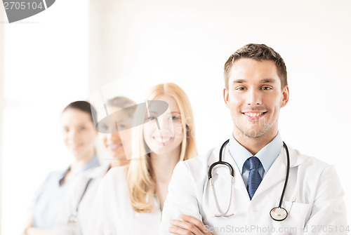 Image of male doctor in front of medical group