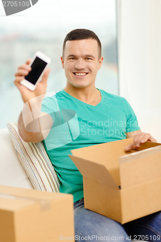 Image of opening cardboard box and taking out smartphone