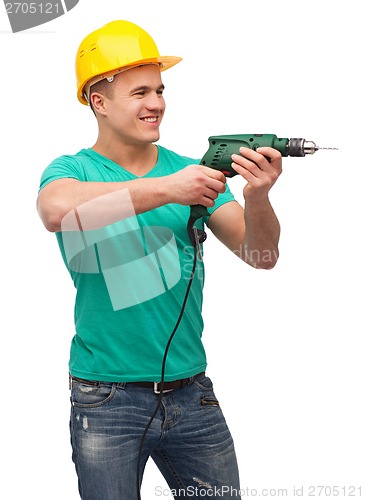Image of smiling manual worker in helmet with drill machine