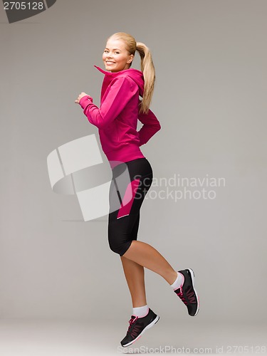 Image of sporty woman running or jumping