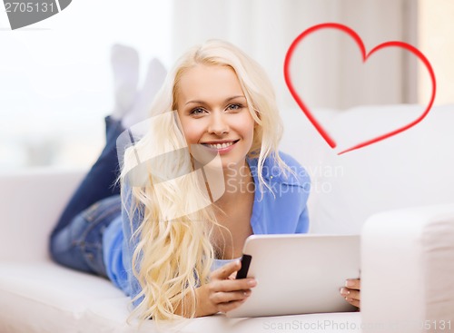 Image of smiling woman with tablet pc computer at home