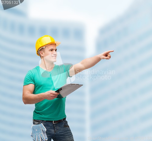 Image of smiling man in helmet with clipboard