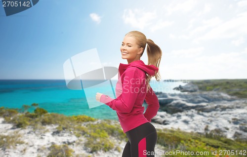 Image of sporty woman running or jumping