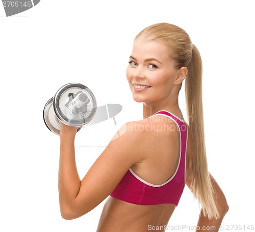 Image of smiling woman with heavy steel dumbbell