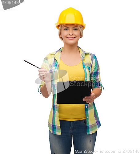 Image of smiling woman in helmet with clipboard