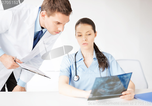 Image of two medical workers looking at x-ray