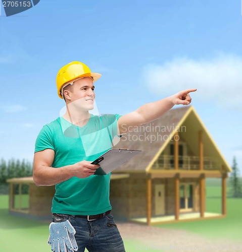 Image of smiling man in helmet with clipboard