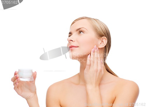 Image of woman applying cream on her skin