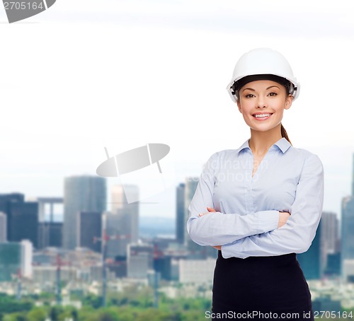 Image of friendly smiling businesswoman in white helmet