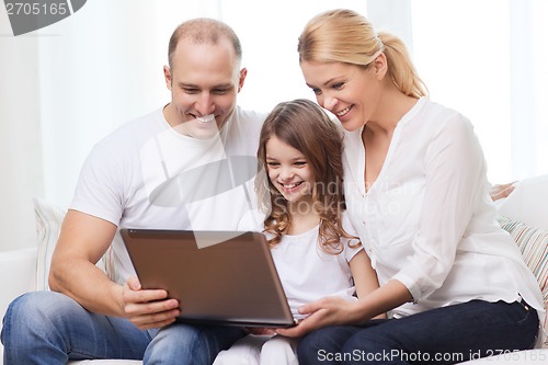 Image of parents and little girl with laptop at home