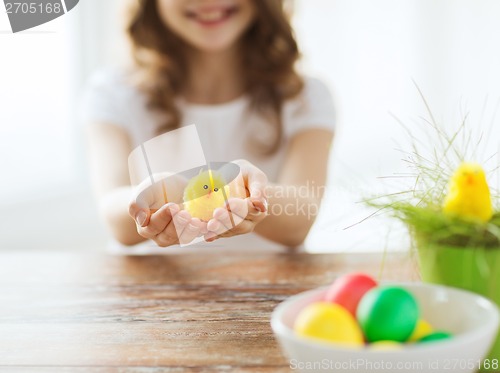 Image of close up of girl holding yellow chiken toy