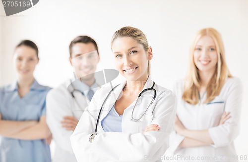 Image of female doctor in front of medical group