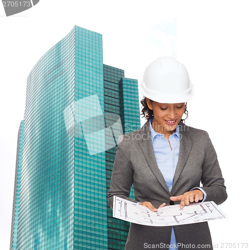 Image of businesswoman in white helmet with blueprint