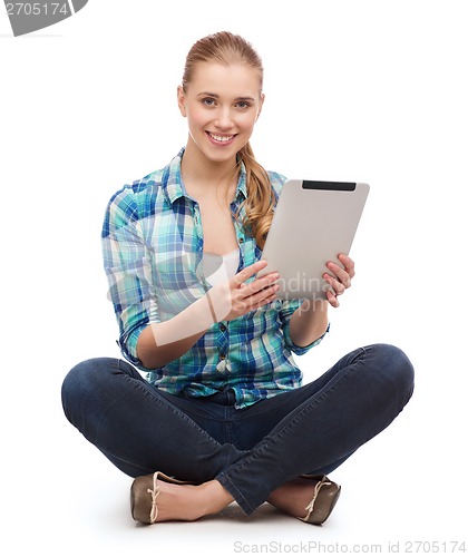 Image of young woman in casual clothes sitting on floor