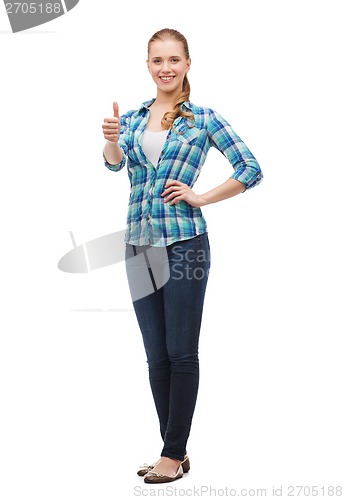 Image of young woman in casual clothes showing thumbs up