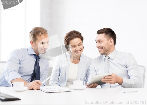 Image of business team having fun with tablet pc in office