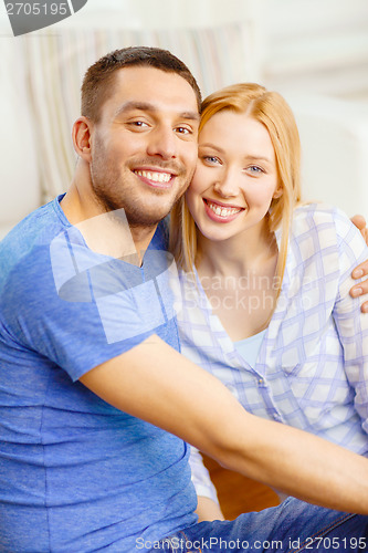 Image of smiling happy couple at home