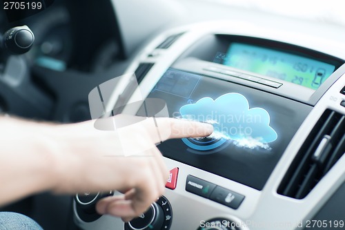 Image of man using car control panel