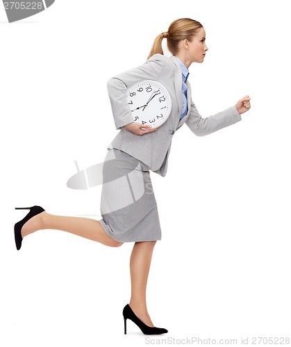 Image of calm young businesswoman with clock running